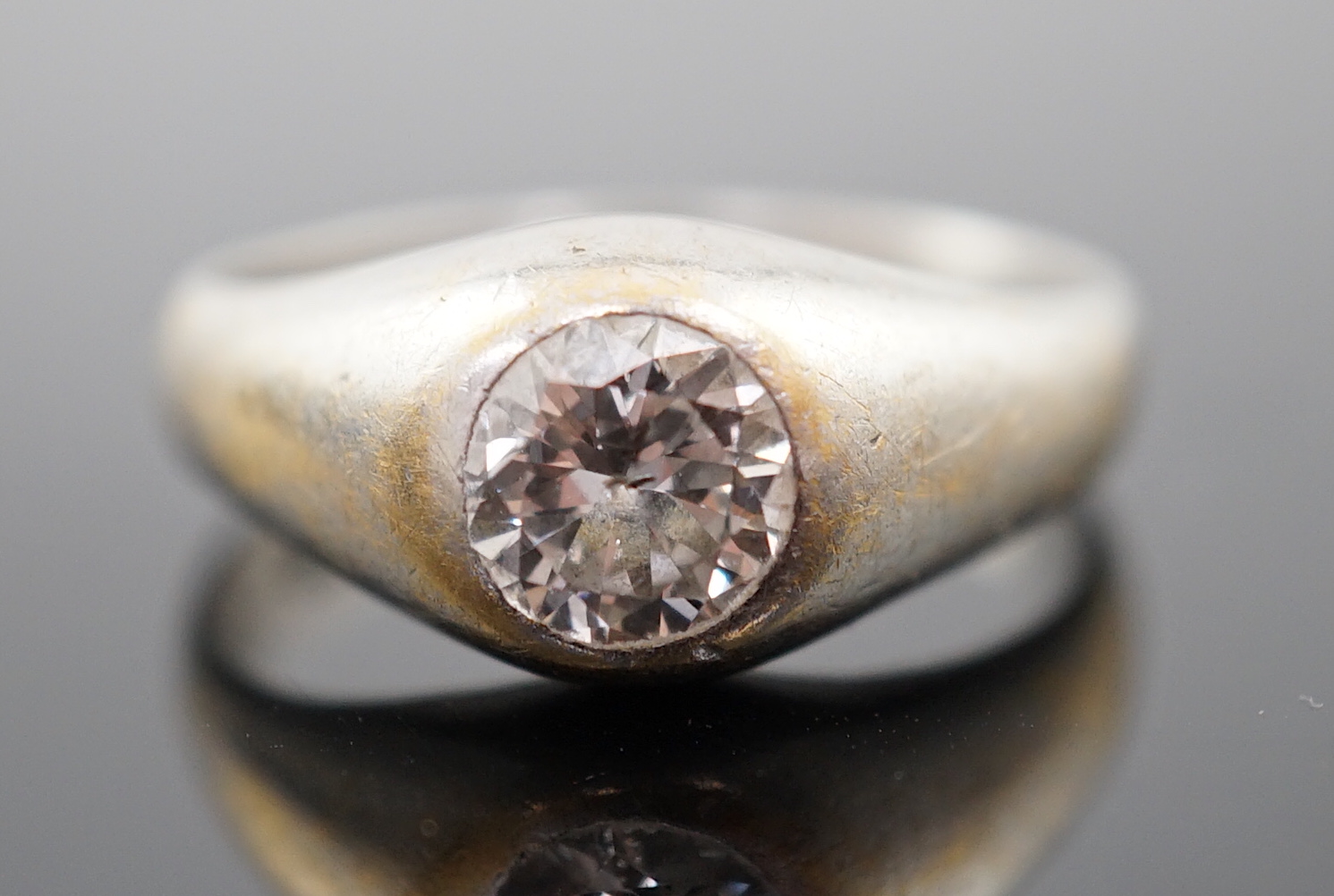 An 18ct white gold and gypsy set solitaire diamond ring